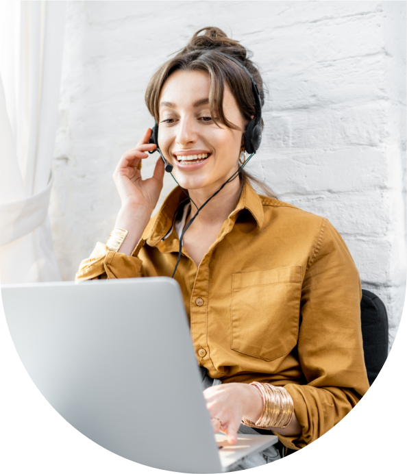Smiling female tutor teaching online with headset and laptop