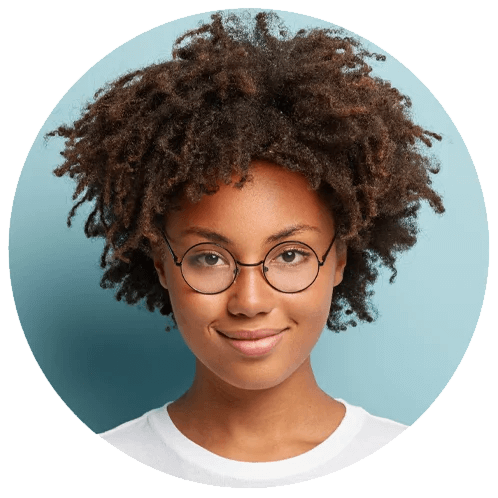 Smiling young woman with curly hair and glasses